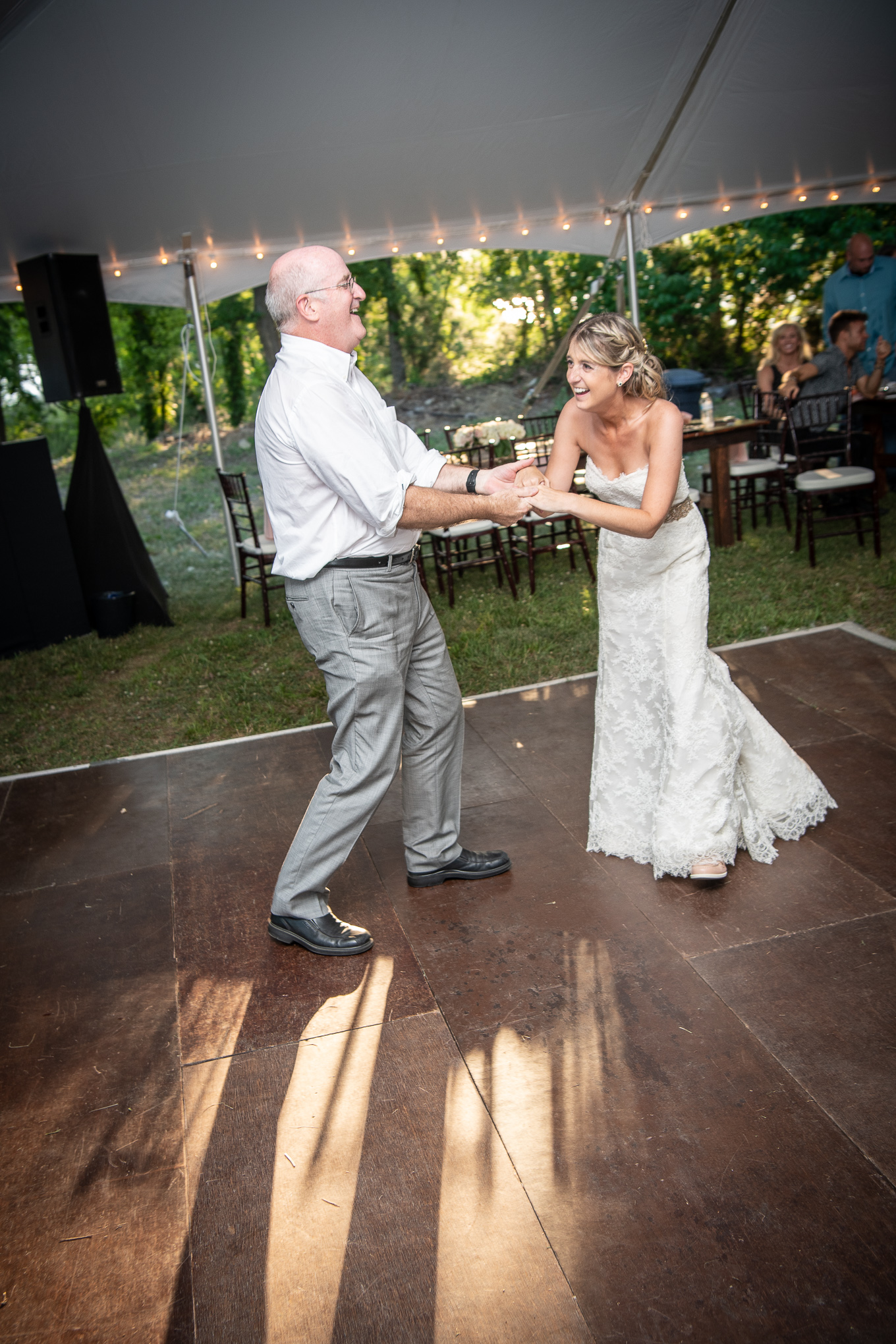 father and bride laughing and dancing 
