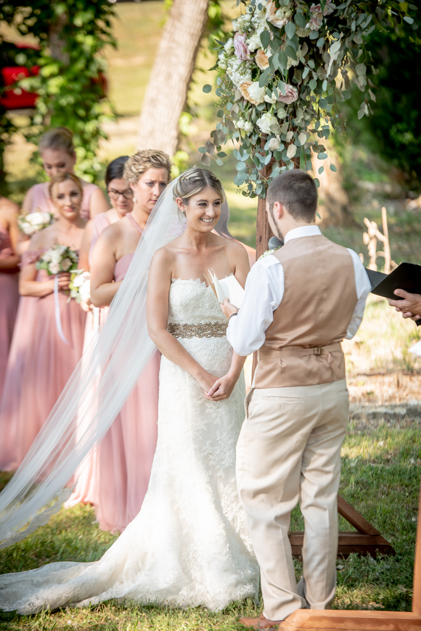 bride smiling at the groom during ceremony 