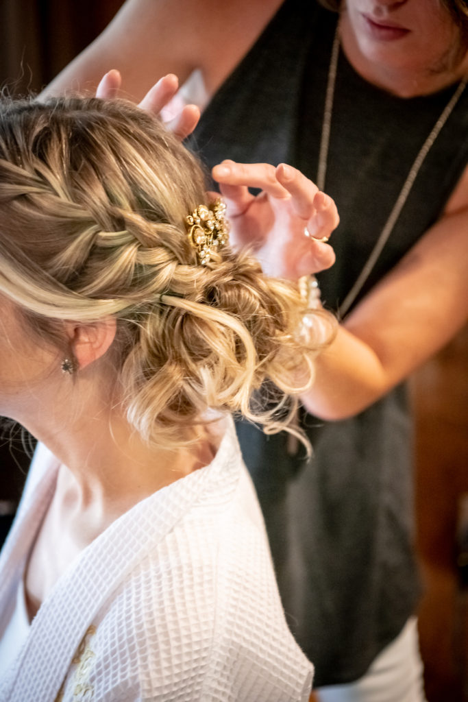 bride getting her hair done for her wedding 